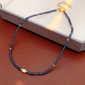 Detail of dark blue beaded necklace featuring a white baroque pearl and gold accents - Blue (Gift Box)