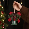 Detailed close-up of dark green Christmas bell with red bow and pine cone decoration - Green