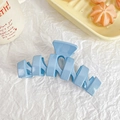 Sky blue matte hair claw clip with geometric hollow design on a white background - Blue