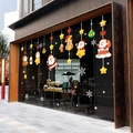 Christmas window stickers featuring Santa Claus and snowflakes on a glass storefront - Happy Santa 6113