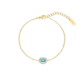 Macro shot of gold bracelet with oval blue gemstone and white rhinestone halo detail - Dark Blue Oval Style (B2326-GO-B)