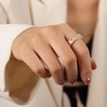 Golden geometric ring featuring rectangle-cut cubic zirconia in a modern pave setting - Type C White