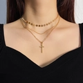 Macro detail of layered gold necklace with sequin choker and polished cross pendant - HS1459-11 Gold 3-Layer Sequin Cross Necklace