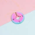 Macro shot of 22mm rainbow stainless steel compass pendant with N-E-S-W lettering - 22mm / Rainbow Color (Clearance)