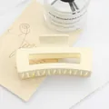 Close-up of large cream matte rectangle hair claw clip with a hollow design - 1# Pearl White Shell