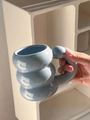 Close-up of a blue ceramic mug with a creative stacked ball design and spherical handle - Blue