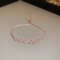 Macro view of rose gold adjustable bracelet featuring six square cubic zirconia charms - Rose Gold Square Zirconia (5076371384562)