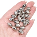 Close-up of silver CCB irregular oval beads for DIY jewelry making on a palm - Rhombus 9x13mm (10pcs/pack)