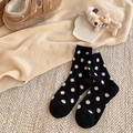 Warm black wool socks with white polka dots for women in a cozy winter home setting - One Size / Black