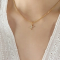 Golden titanium steel necklace with sparkling zircon-studded letter X pendant on neck - Letter X / Gold