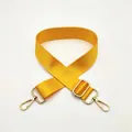 Close-up of bright yellow nylon woven strap with adjustable gold metal buckle hardware - Yellow