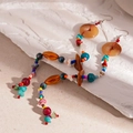 Detalle de pendientes étnicos largos con piedras de resina de colores y ganchos plateados - Gancho de oreja colorido