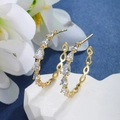 Close-up of gold hoop earrings with pear-cut cubic zirconia on a dark blue background - Teardrop Pear Large Hoop (065)