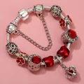 Close-up of silver charm bracelet with red floral pendants, heart beads and crown charm - Sl023318/1216-9