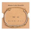 Detail of gold Morse code double-layer bracelet with crystal rhinestones on display card - Bad Ass Gold