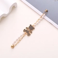 Golden bear charm bracelet with pearls and dark rhinestones on white background - Rhinestone Teddy Bear Artificial Pearl Spliced Magnetic Chain (K999)