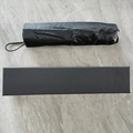Black folding umbrella with matching gift box featuring a minimalist middle finger design - Manual Middle Finger (Gift Box)