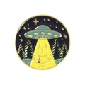 Detail of a round UFO campfire enamel pin with yellow beams and forest landscape - UFO Camping Style (XZ4310)