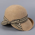 Detail of light brown woven straw hat featuring checkered bow and gold metal pendant - M (56-58cm) / Yellow