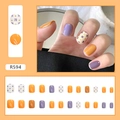 Floral retro press-on nails in orange and purple tones with model hand display - R594 Taro Ball Dessert