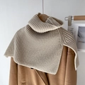 Knitted off-white high neck scarf shawl layered on a brown wool coat in minimalist style - Apricot