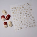 Macro detail of gold embossed Christmas nail stickers with snowflake and tree patterns - Christmas Theme Gold Embossed Style (CO-067)