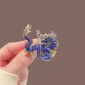 Detailed close-up of a blue and gold dragon brooch with exquisite enamel texture - Blue