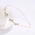 Elegant gold metal headband featuring sparkling rhinestone bow knots on a tea cup - Bowknot Style