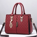 Women's burgundy tote bag with 3D geometric embossing and leaf charm accessory - Burgundy