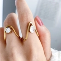 Detail of gold-plated wavy rings featuring teardrop and round zircon stones on a model - Gold - Irregular Round Zircon