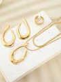 Detailed view of gold jewelry set with thick ring and earrings on a white plaster stand - Three-Piece Set / Gold