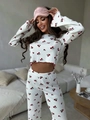 Close-up of cherry print pajama set featuring ribbed texture and bell sleeve details - S / White with Cherries