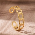 Detailed view of an 18K gold plated stainless steel open cuff with hollow chain link design - Ellipse