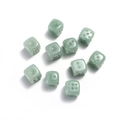 Macro shot of 10 green jade stones 15mm six-sided dice set on a white background - Green Aventurine