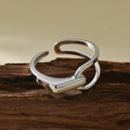 Minimalist silver geometric open ring displayed on a natural wood textured stand - Adjustable Open / White Gold