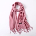Detail showing soft pink cashmere scarf texture with delicate fringe and label - Leather Red