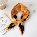 Pleated yellow and black silk neck scarf with gold patterns tied in a bow knot - Hibiscus Flower Yellow