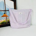 Close-up of light purple striped canvas tote showing fabric texture and brand label - Purple Pink Stripes