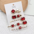 Vintage gold hair clip set with ruby red crystals and pearls on display card - Red