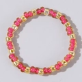 Handmade beaded ring with pink, gold, and amber glass seed beads in a symmetric pattern - Amber Pink and Gold