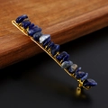 Detail shot of blue raw crystal stones hand-wrapped with gold wire on a metal hair clip - Blue Lace Agate + Gold Clip