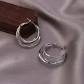 Three-ring interlocking hoop earrings in polished silver finish with a modern minimalist style - E-067---Platinum