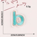 Letter B embroidered iron-on patch in teal blue with gold borders, 2.5cm height - Letter-B