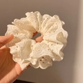 Close-up of white lace scrunchie with intricate hollow-out floral patterns and ruffles - Double Layer Lace Cream