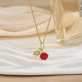 Detail of gold necklace featuring red zircon pendant and pavé-set bud element charm - Gold Red Gem Tulip