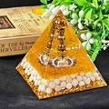 Orgone pyramid with gold foil, white crystal stones, metal coil, and Buddha symbol - 8cm / 16 Vajra