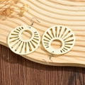 Minimalist beige wooden earrings with geometric hollow design on a rustic wood background - Off White