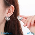 Silver hollow heart-shaped earrings with white faux pearl inlay on a model - 24x20mm / Steel