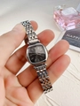 Detail of square silver steel watch with black dial held in hand for an elegant style - Silver Black Dial