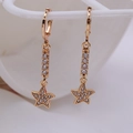 Elegant gold star drop earrings featuring pavé rhinestones on a long dangle design - Star